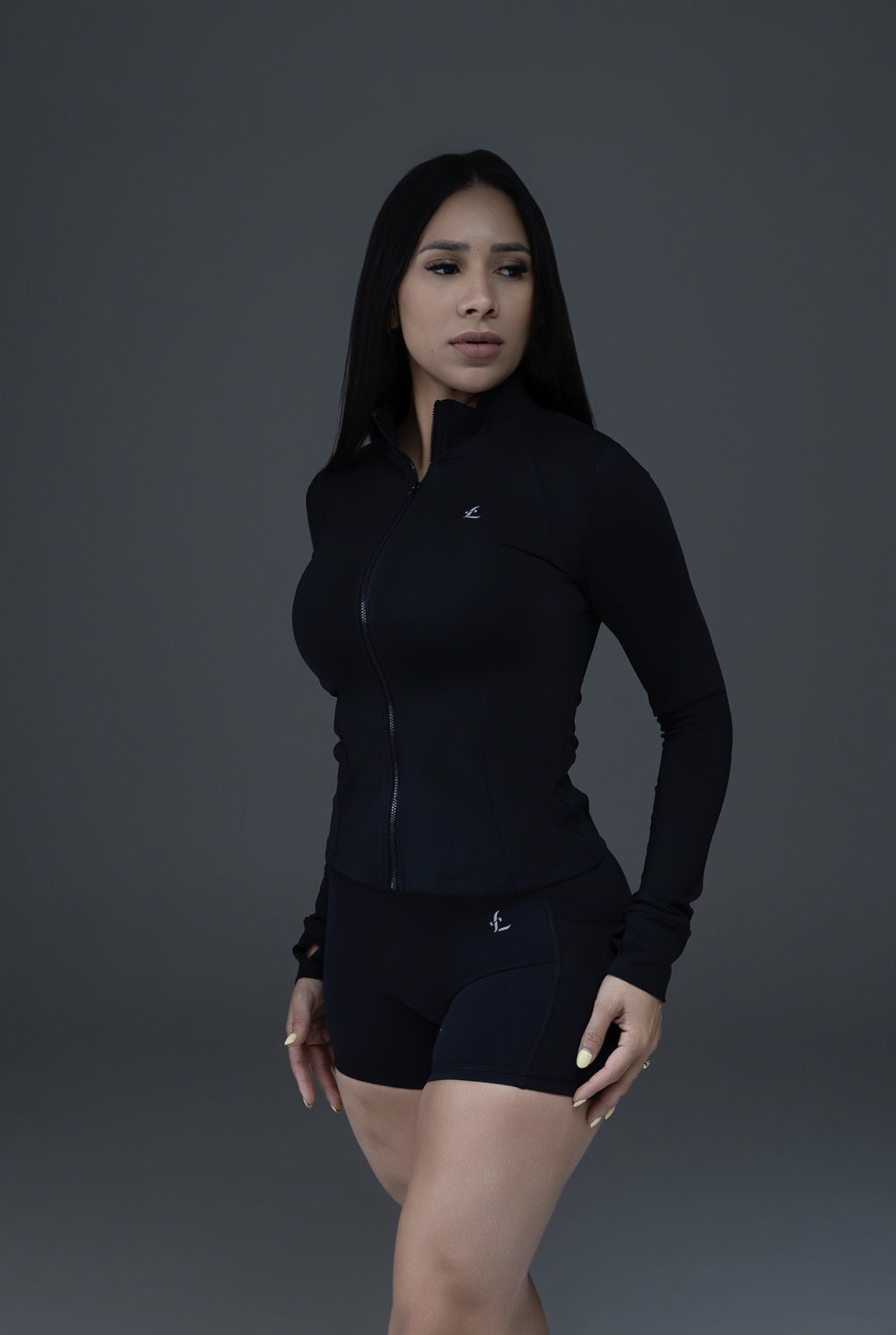 Model wearing the Lisboa Fit black sculpt zip jacket and performance shorts